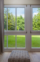 Fototapeta premium view of the window in the room on a green park on a sunny summer day