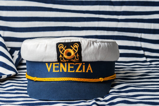 Souvenir cap of the sea captain with the inscription in Italian "Venice" against the background of the striped vest.