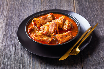 Braised Pork pieces in a black bowl