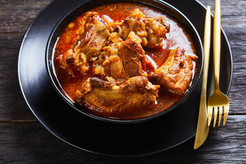 Braised Pork pieces in a black bowl