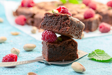 Brownie slices with raspberries and pistachios.