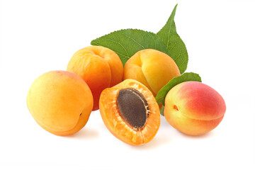 Few whole apricots and half with twig isolated on white