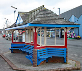 Fototapeta na wymiar Brightly coloured wooden bus shelter on the seafront at Minehead in Somerset