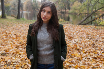 Portrait of walking young girl in autumn park