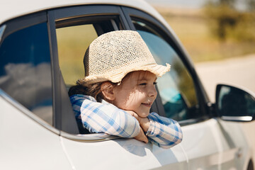 happy little girl go to summer travel trip in the car. High quality photo
