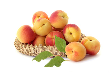 Delicious apricots  in a wicker basket isolated on white
