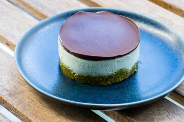 Vegan Raw Round Cheesecake with Mint, Bitter Chocolate and Pistachio Nut Paste.