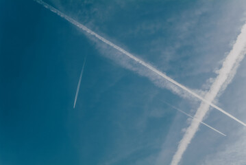 Airplane trails on blue sky