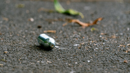 Discarded empty nitrous oxide gas canister used for drugs