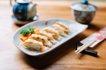 Food series: Gyoza (pot sticker) on wooden table in ryokan, traditional Japanese hotel