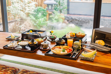 Ryokan series: Breakfast set of Japanese and American style on wooden table in ryokan, traditional Japanese hotel