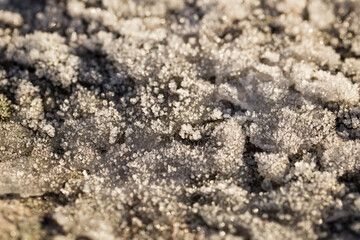 Ice crystals on the ground of a hill in Horton, Norway. Macro close-up of texture of ice formed on the rocks
