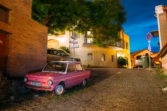 Parked Rarity Tuning Pink Minicar Zaporozhets On Paved Street In Old District Of Tbilisi, Georgia