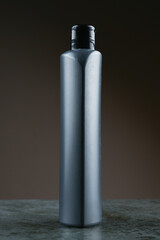 mockup of a gray plastic bottle on a dark background