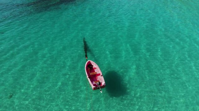 Red boat hovering over turquoise  Water in Lofoten Norway