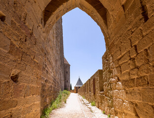 Wide fortified walls with walkways and arches of medieval castle of Carcassonne town