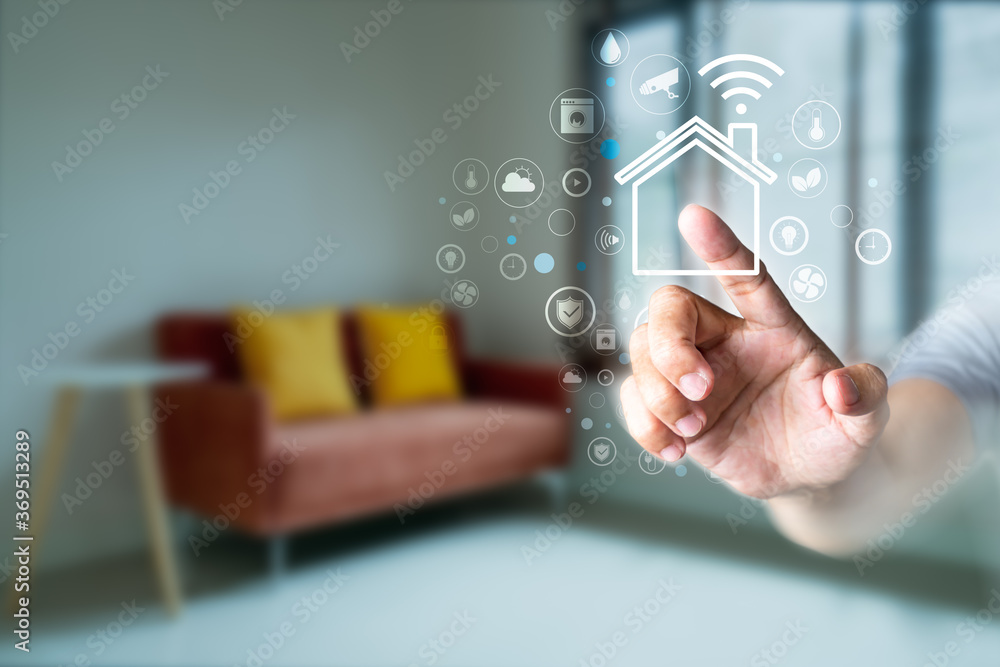Poster man's finger touching the icons of smart home application on virtual screen with blurred room backgr