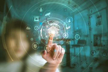 Woman hand touching the icons of smart home application on virtual screen. Home automation Concept