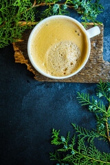 coffee hot foam cocoa cup or hot chocolate twigs spruce on the table new year mood Menu serving size. food background copy space 