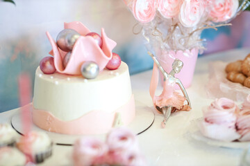 A close up of a vase of flowers on a table and cake