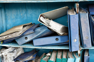 Damaged documents on old shelves
