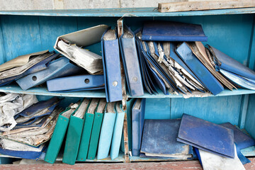 Damaged documents on old shelves
