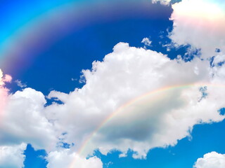 rainbow at sunset sky fluffy clouds and sunlight beams skyline  nature landscape weather forecast