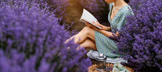 Close up of a young woman reading a book in the lavender field