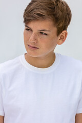 Boy teenager teen male child wearing a white t-shirt - obrazy, fototapety, plakaty