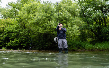 Fishermen is holding the fishing rod stock photo