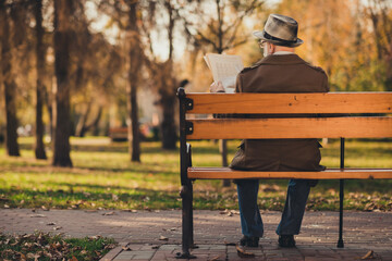 Rear back behind view photo of old white haired grandpa husband street walk lonely sit bench with...