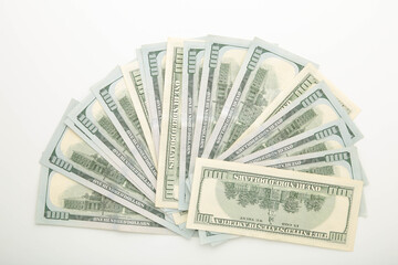 A pile of hundred dollar bills on white background with copy space
