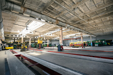 Fototapeta premium Trolleybuses parked at a trolley depot hangar for technical inspection, depot maintenance
