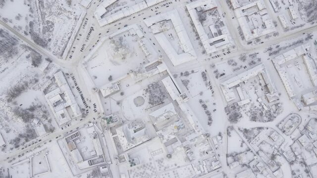 90 degrees rotating aerial shot of a provincial town in snow