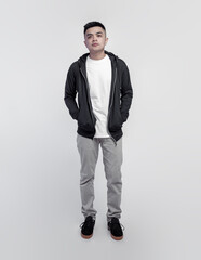 Young handsome man wearing black hoodie and white t shirt isolated on background