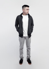 Fototapeta premium Young handsome man wearing black hoodie and white t shirt isolated on background