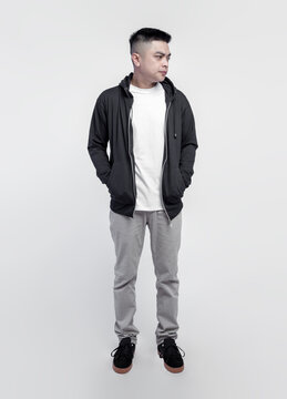 Young handsome man wearing black hoodie and white t shirt isolated on background