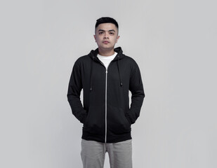 Young handsome man wearing black zip hoodie isolated on background suitable for mockup
