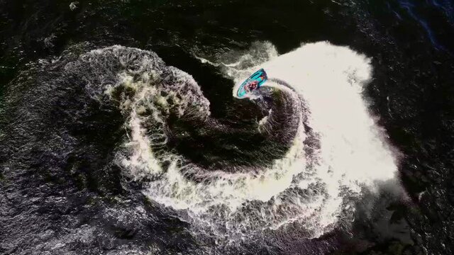 Overhead view of a man having fun carving it up on a jetski at spring break. August 2020
