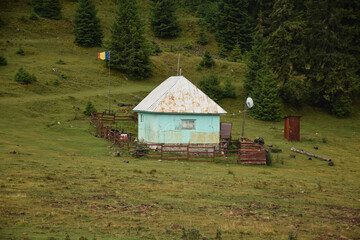 Old house with flag in Romanian mountains