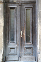 vintage entrance wooden gray door with glass close-up