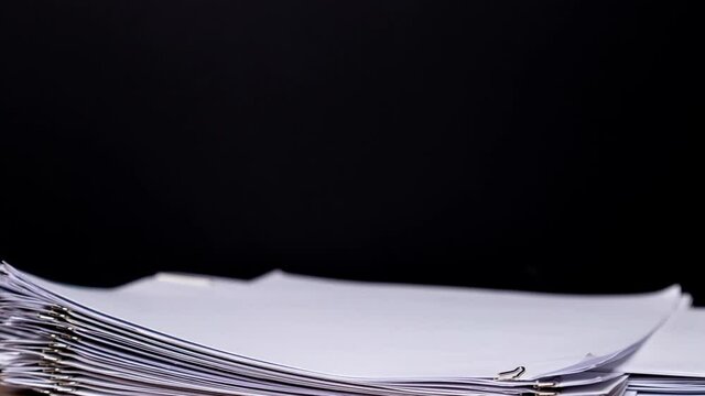 4K Stop of motion close-up stack overload document report paper with paperclip place increase on yellow background, business and education concept footage paperless used. 