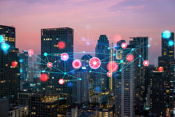 Hologram of abstract technology glowing icons, panoramic cityscape of Bangkok at sunset, Asia. The concept of worlds technological changes. Double exposure.