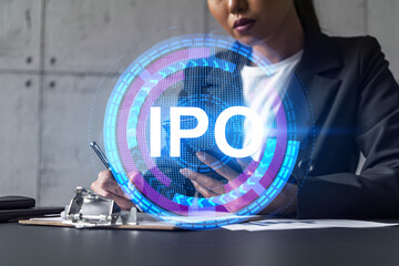 Businesswoman taking notes and IPO hologram. Double exposure. Business technology initial primary...