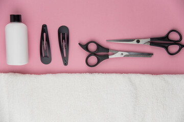 Professional hair dresser tools with copy space. Hair stylist equipment set on pink background....
