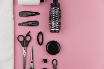 Professional hair dresser tools with copy space. Hair stylist equipment set on pink background....