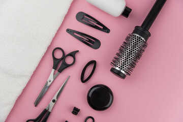 Professional hair dresser tools with copy space. Hair stylist equipment set on pink background....