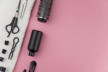 Professional hair dresser tools with copy space. Hair stylist equipment set on pink background....