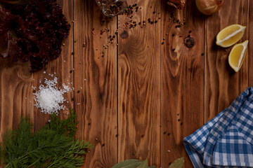 Wooden background with spices and vegetables for designer