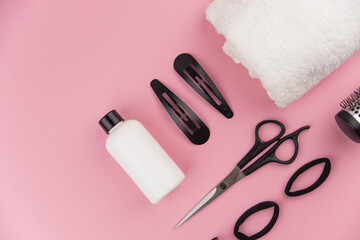 Professional hair dresser tools with copy space. Hair stylist equipment set on pink background....